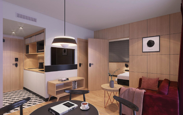 Een van de kamers met kitchenette met de deur open naar de slaapkamer.